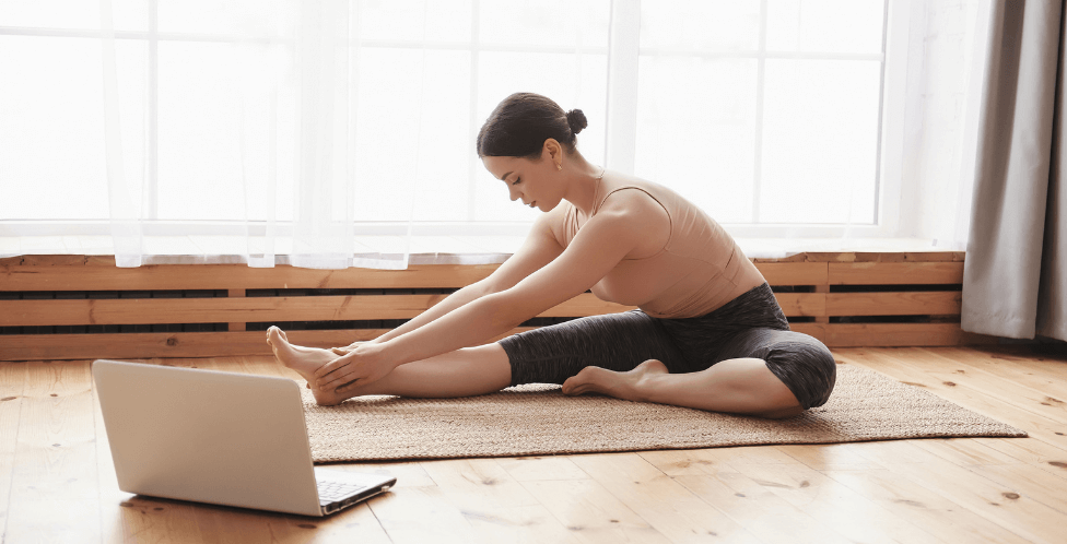 Woman on a yoga mat in a bright room